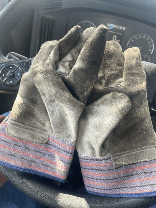 Work gloves on a truck steering wheel β ready for the hands-on pre-trip inspection